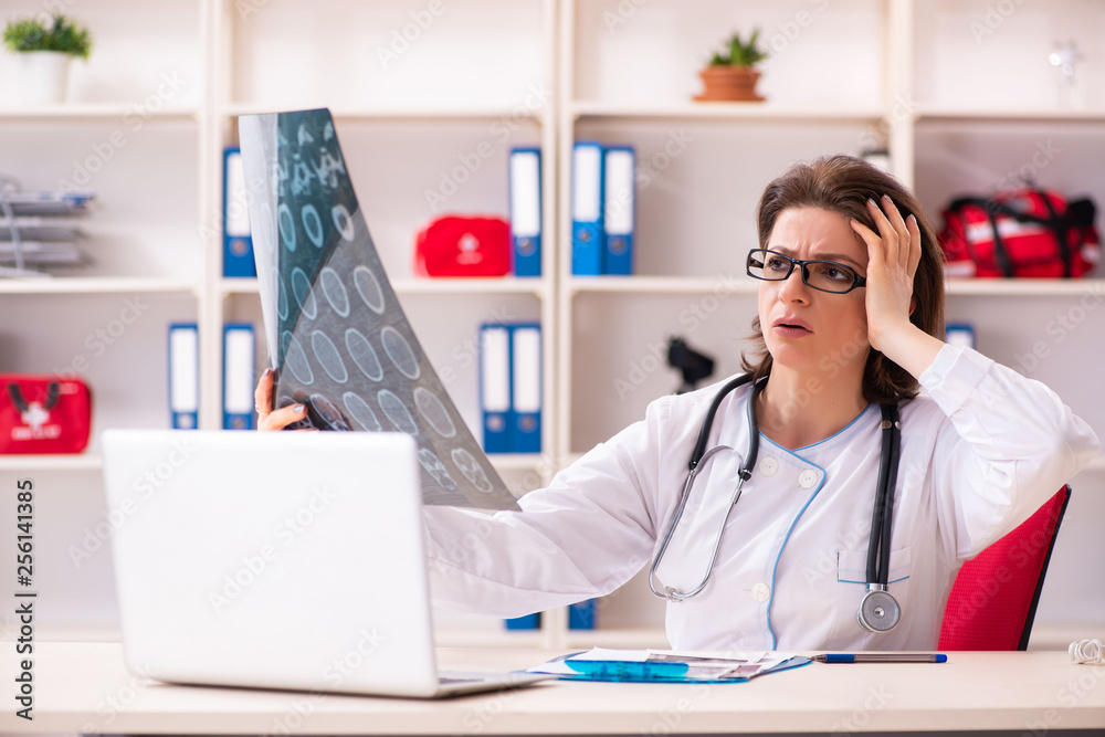 Aged female doctor radiologist in the clinic Aged female doctor radiologist in the clinic