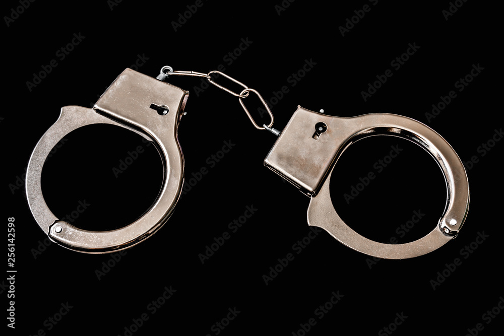 Metal handcuffs isolated on black Metal handcuffs isolated on black