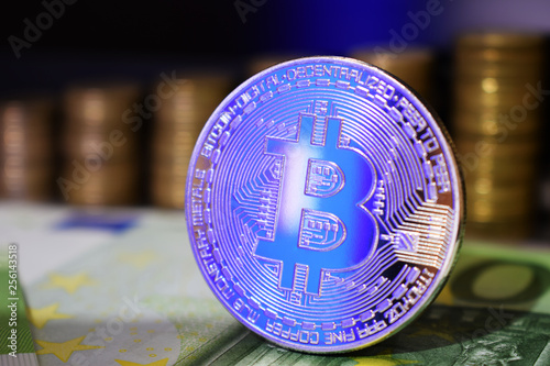 Physical Bitcoin BTC coin on a background with money photo