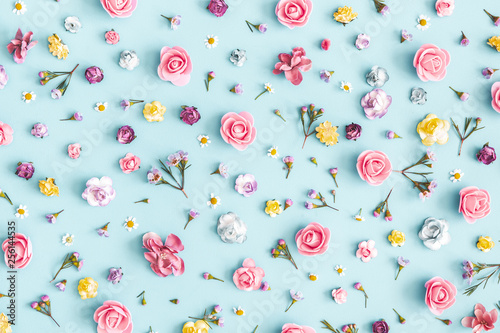 Flowers composition. Pattern made of colorful flowers on pastel blue background. Spring, easter, summer concept. Flat lay, top view photo
