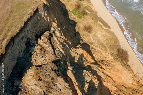 Mountain landslide in an environmentally hazardous area. Large crack in ground, descent of large layers of dirt. Deadly danger at foot of landslide mountain. Soil erosion Avalanche. Steep coast, crack