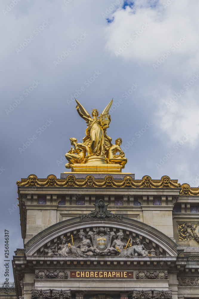 Golden statue on the frontal facade of Palais Garnier in Paris, France