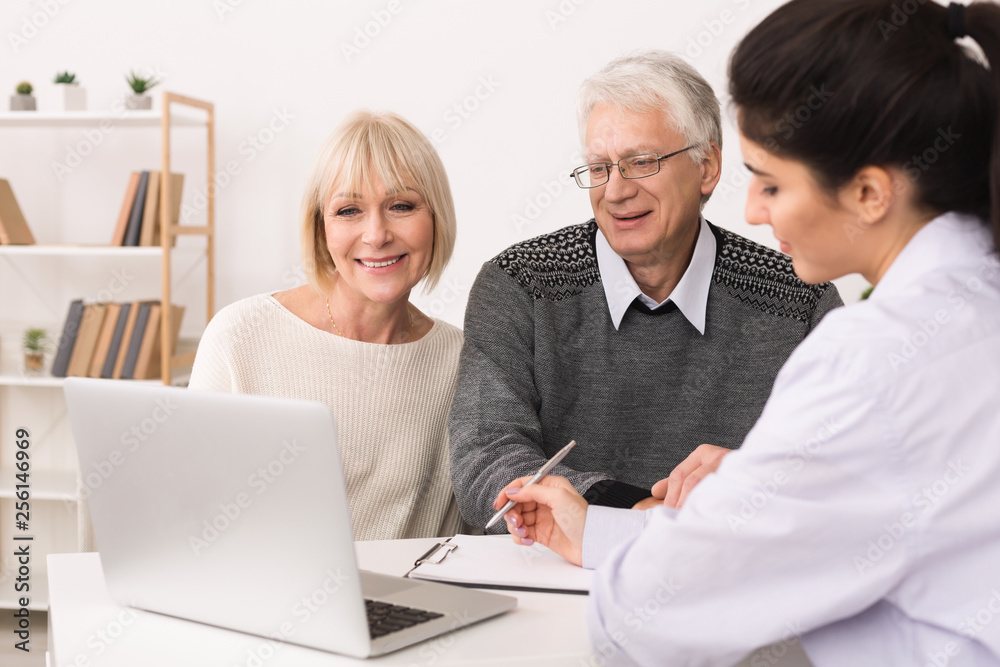 Elderly couple discussing treatment plan with doctor Elderly couple discussing treatment plan with doctor