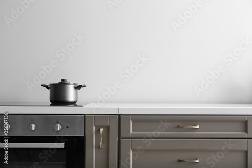 Saucepan on electric stove on counter in kitchen photo