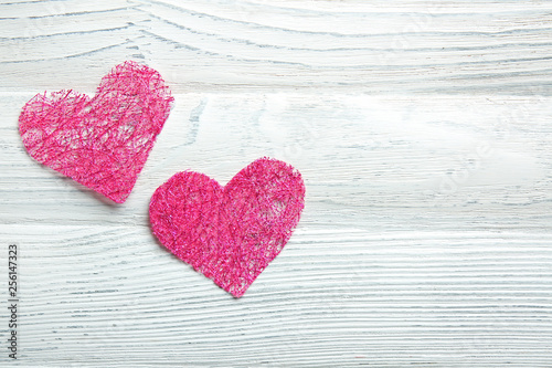 Pink hearts on white wooden background
