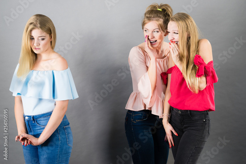 Woman being gossiped by two females