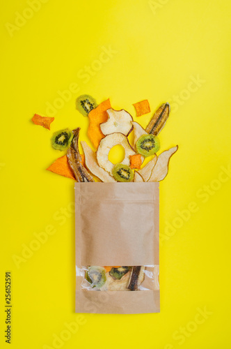 Dried fruits and vegetables slices in craft paper bag