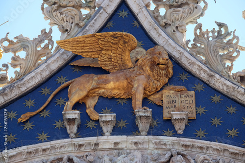 Statue golden winged lion, symbol of Venice on the Basilica of St. Mark on Piazza San Marco, Venice, Italy, UNESCO World Heritage Sites 