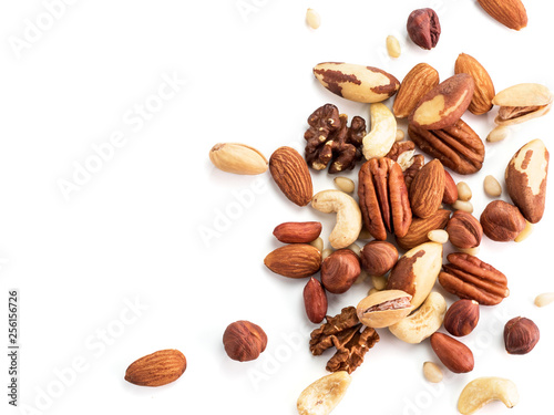 Background of nuts - pecan, macadamia, brazil nut, walnut, almonds, hazelnuts, pistachios, cashews, peanuts, pine nuts.Copy space. Isolated one edge on white with clipping path. Top view or flat lay photo