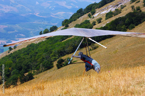 Hang glider pilot in Italian mountains photo