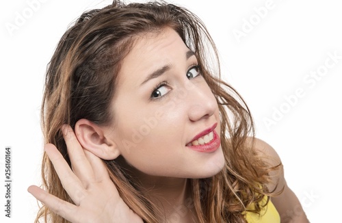 Wallpaper Mural young woman listening gossip with her hand next to her ear Torontodigital.ca