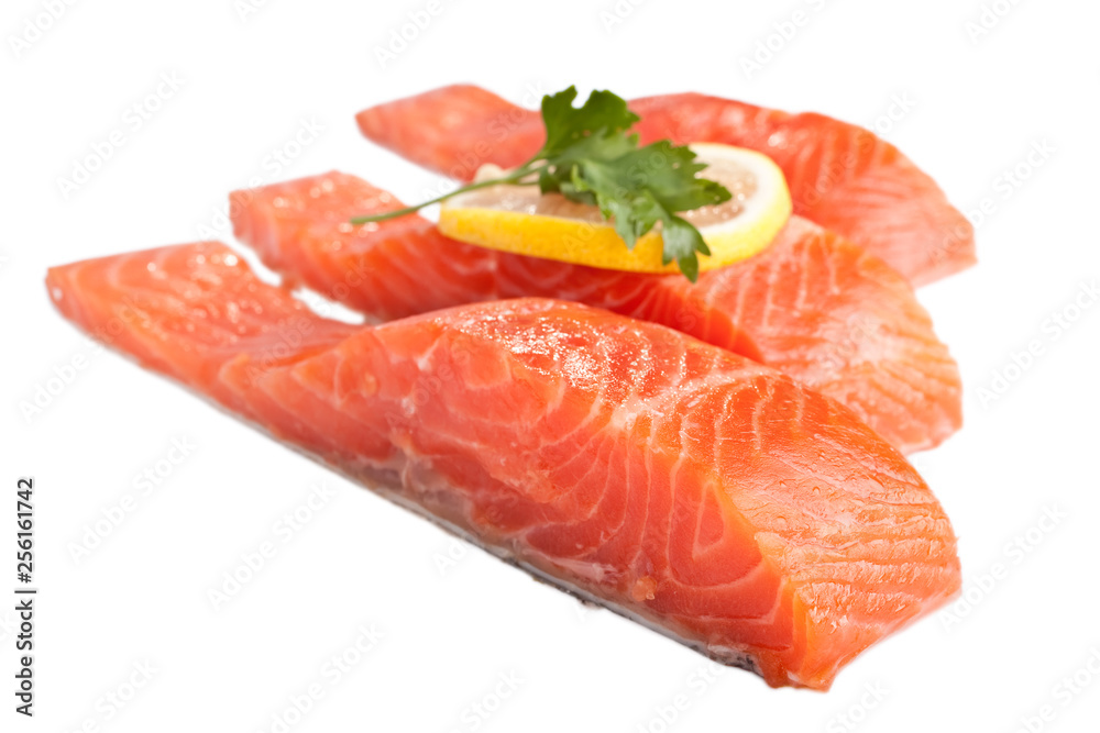 three fresh salmon steaks with lemon isolated on white