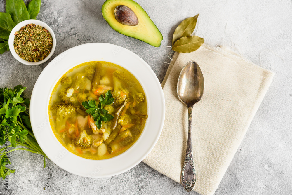 Tasty vegetables and spices soup on a gray concrete background. It can be used as a background Tasty vegetables and spices soup on a gray concrete background. It can be used as a background