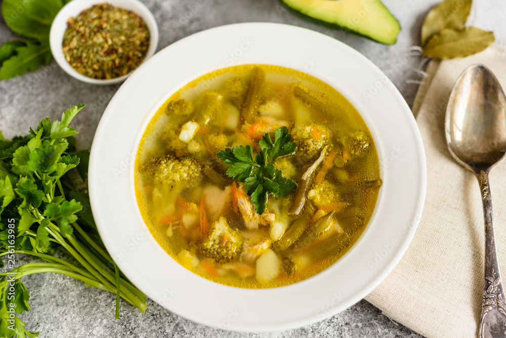 Tasty vegetables and spices soup on a gray concrete background. It can be used as a background Tasty vegetables and spices soup on a gray concrete background. It can be used as a background