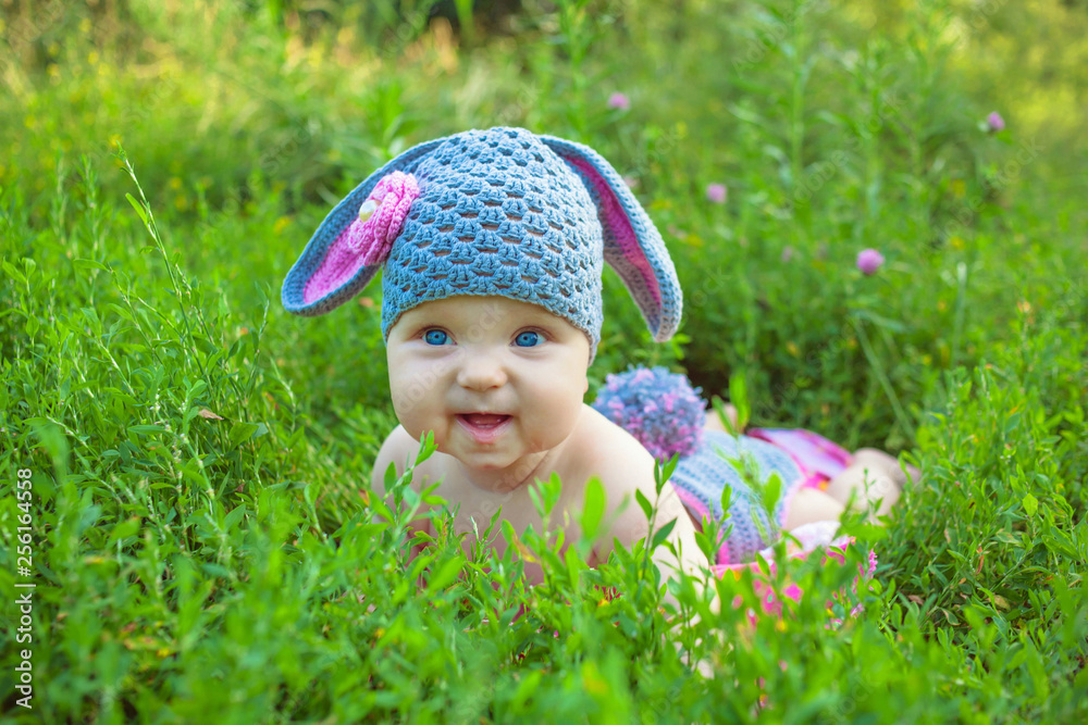Smiling baby kid posing like an Easter bunny. Smiling baby kid posing like an Easter bunny.