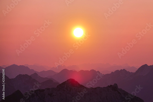 LENS FLARE  Bright morning sun shines on the stunning mountain range in Slovenia