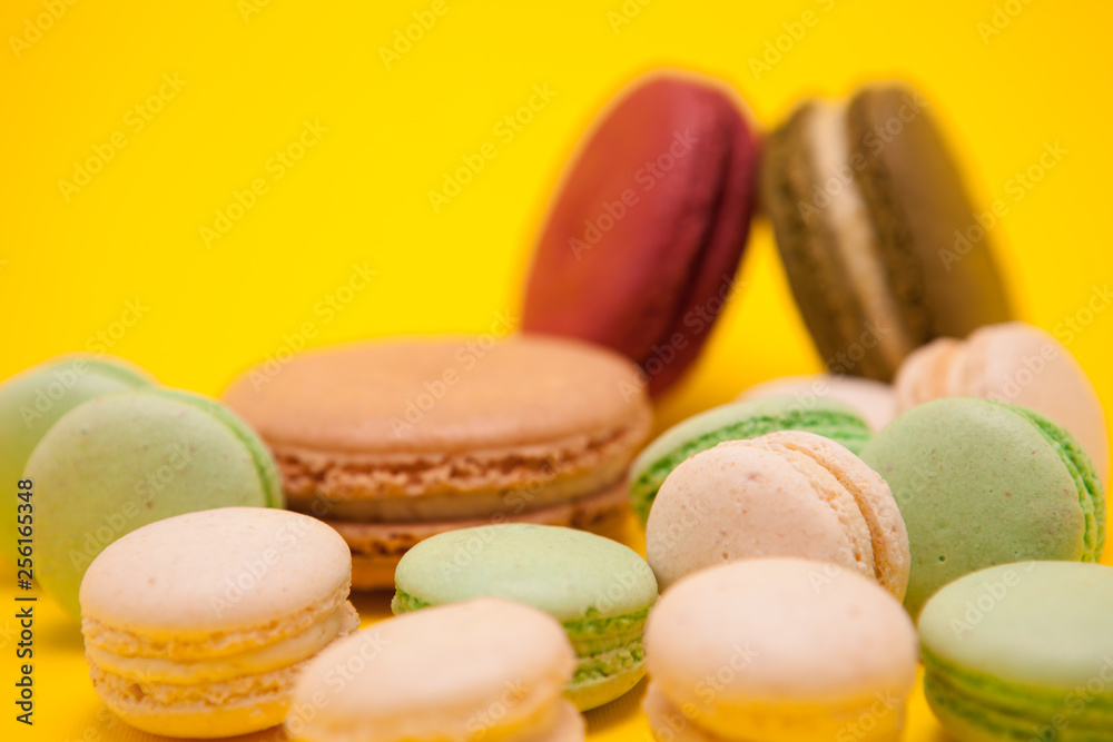 French delicious macaroons dessert over yellow background
