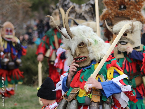 Zemen, Bulgaria - March 16, 2019: Masquerade festival Surva in Zemen, Bulgaria. People with mask called Kukeri dance and perform to scare the evil spirits. © georgidimitrov70