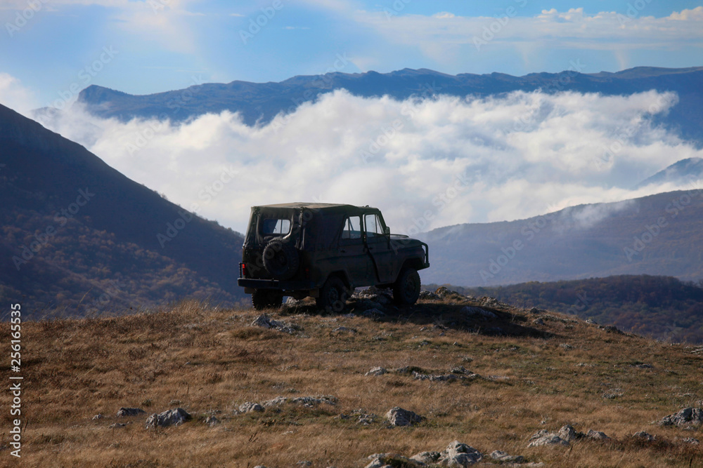 Travel by car in the mountains on par with clouds