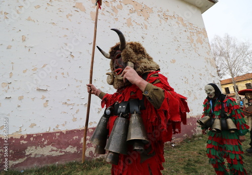 Zemen, Bulgaria - March 16, 2019: Masquerade festival Surva in Zemen, Bulgaria. People with mask called Kukeri dance and perform to scare the evil spirits. photo