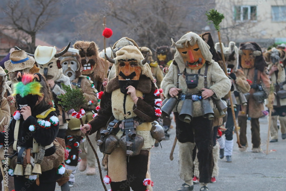 Obraz premium Zemen, Bulgaria - March 16, 2019: Masquerade festival Surva in Zemen, Bulgaria. People with mask called Kukeri dance and perform to scare the evil spirits.