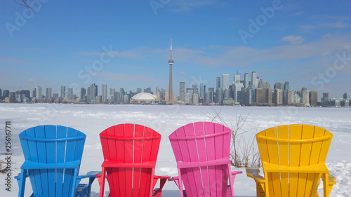 Photography View of Toronto city skyline seen form Toronto Islands with colourful chairs