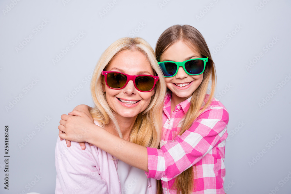 Close up photo cheer two people blond haired she her granny little daughter granddaughter hugging ready holiday celebrate wear specs pink plaid checkered shirt sweater isolated grey background Close up photo cheer two people blond haired she her granny little daughter granddaughter hugging ready holiday celebrate wear specs pink plaid checkered shirt sweater isolated grey background