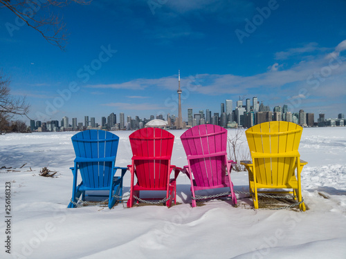 Photography View of Toronto city skyline seen form Toronto Islands with colourful chairs