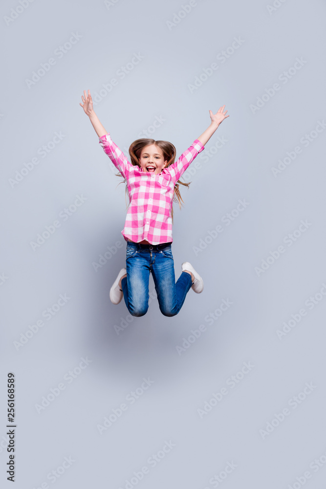 Full length body size vertical photo blond haired she her little lady girl cheerleader laugh laughter jump achievement wear casual jeans pink plaid checkered shirt clothes isolated grey background