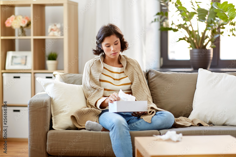 healthcare, cold, hygiene and people concept - sick woman in blanket taking paper tissue from box at home healthcare, cold, hygiene and people concept - sick woman in blanket taking paper tissue from box at home
