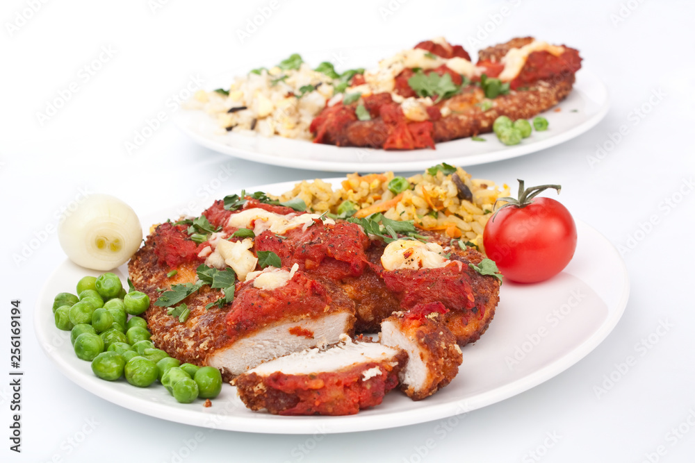 two plates of chicken parmesan on white background two plates of chicken parmesan on white background