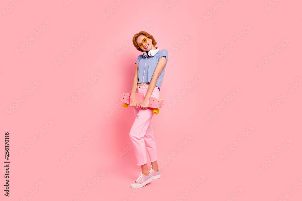 Full length body size view portrait of her she nice charming attractive lovely winsome cheerful cheery girl wearing casual holding in hands roller skate having fun isolated on pink pastel background Full length body size view portrait of her she nice charming attractive lovely winsome cheerful cheery girl wearing casual holding in hands roller skate having fun isolated on pink pastel background