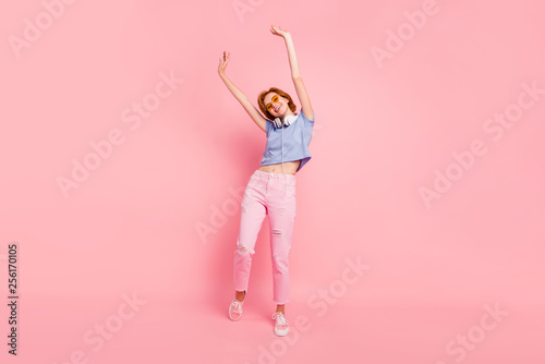 Full length body size view portrait of her she nice cute charming attractive lovely optimistic cheerful cheery girl rejoicing having fun isolated on pink pastel background