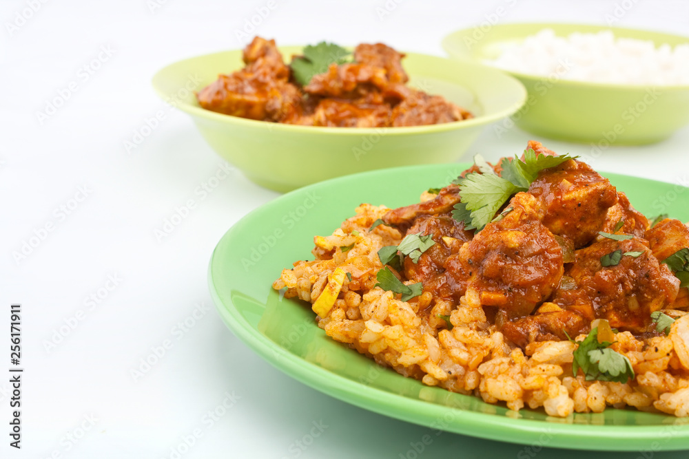 Chicken Curry with basmati rice and coriander leaves on a plate Chicken Curry with basmati rice and coriander leaves on a plate