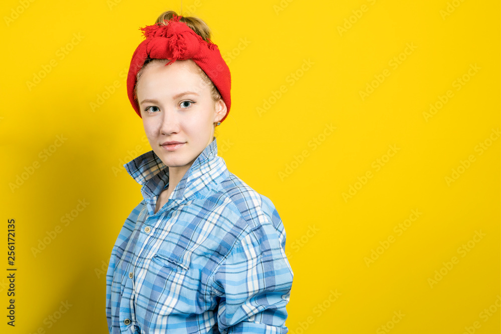 Young beautiful woman thinking looking to the side at blank copy space. Caucasian person in yellow dress and beige lipstick, redhead hair up isolated on blue studio background. Expressive face girl Young beautiful woman thinking looking to the side at blank copy space. Caucasian person in yellow dress and beige lipstick, redhead hair up isolated on blue studio background. Expressive face girl