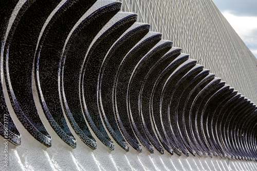 Detail of the facade of a building with ovoid geometric shapes.