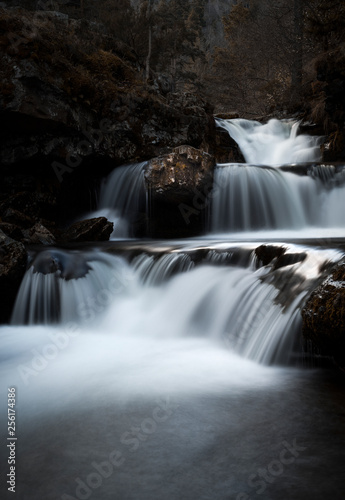 Scene with long exposure waterfall in late autumn