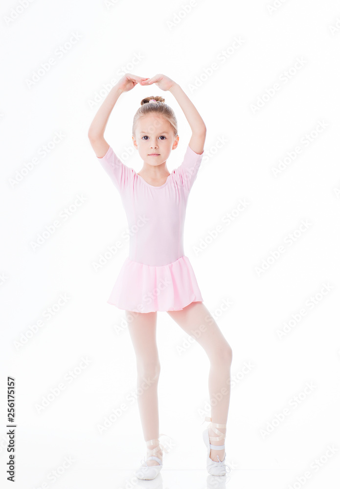 The little ballerina poses in a dancing suit on a white background The little ballerina poses in a dancing suit on a white background