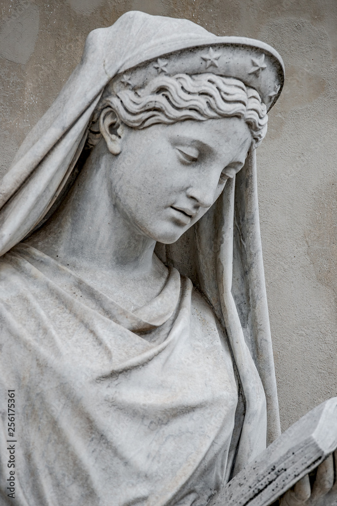 Ancient statue of sensual Italian Renaissance Era woman reading a book, Potsdam, Germany, details, closeup