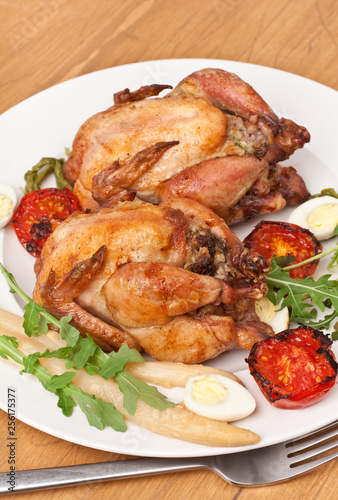 whole grilled chickens garnished with vegetables