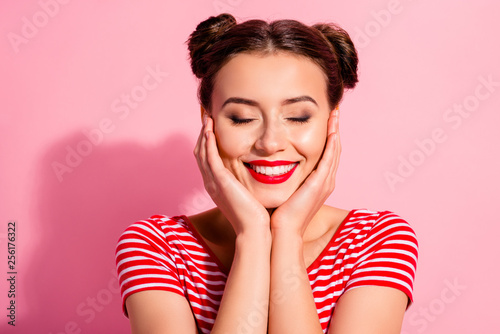 Close up photo beautiful she her lady pretty two buns eyes dreamer closed bright pomade lipstick touch hold arms hands cheeks cheekbones wear casual striped red white t-shirt isolated pink background