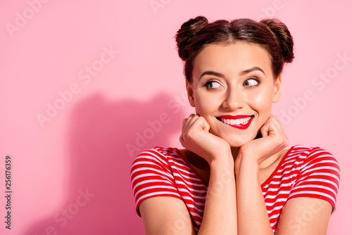 Close up photo beautiful she her lady pretty two buns eyes look empty space bright pomade lipstick touch arms hands chin cheeks wear casual striped red white t-shirt isolated pink background