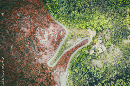 top aerial view of rural roads in a mountain landscape with trees