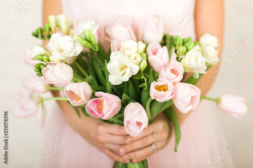 Wedding bouquet of pink tulips in bride's hands