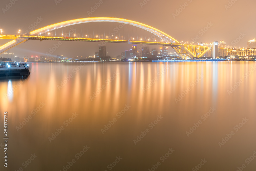 Naklejka premium Night view of Lupu Bridge on Huangpu River, Shanghai city