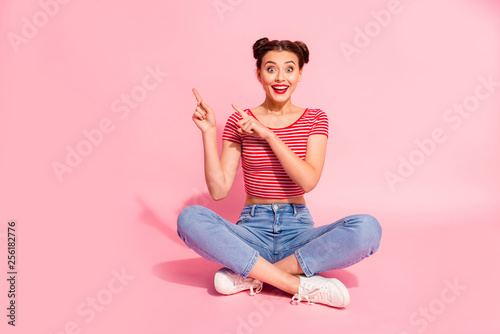 Full length body size photo beautiful she her lady buns pomade lips hand arm finger show low prices black friday wear casual jeans denim striped red white t-shirt sit floor isolated pink background photo