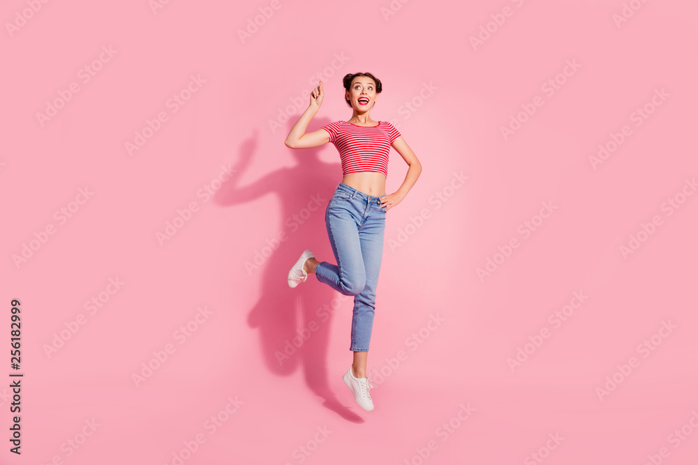 Full length body size photo beautiful she her lady jump high recommend buy buyer new product show look empty space wear casual jeans denim striped red white t-shirt sit floor isolated pink background