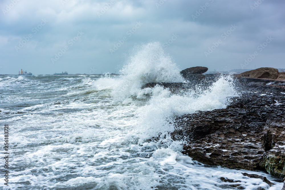 Fototapeta premium Splash of huge waves on a rocky shore