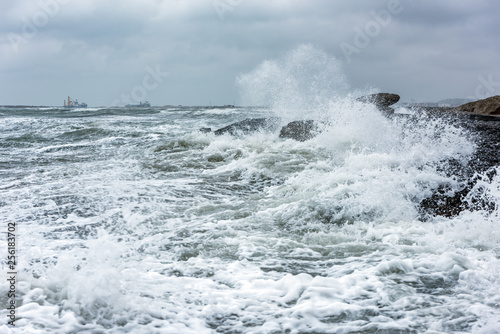 Splash of huge waves on a rocky shore
