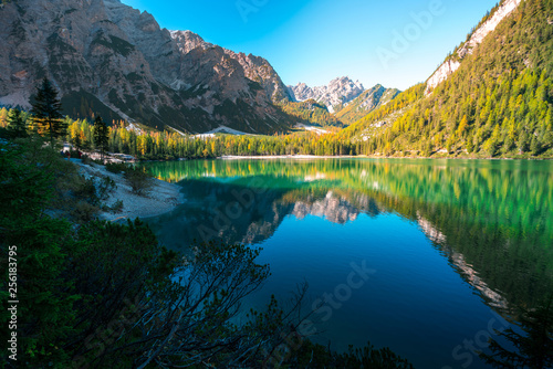 amazing view of braies lake with mountains and forest reflections on the water. northern italy, south tyrol